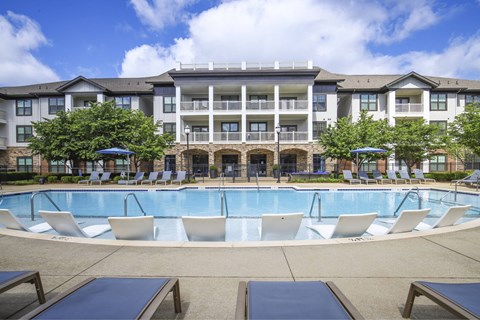 A large building with a pool in front.