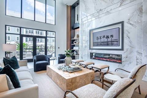 A living room with a fireplace and a painting on the wall.