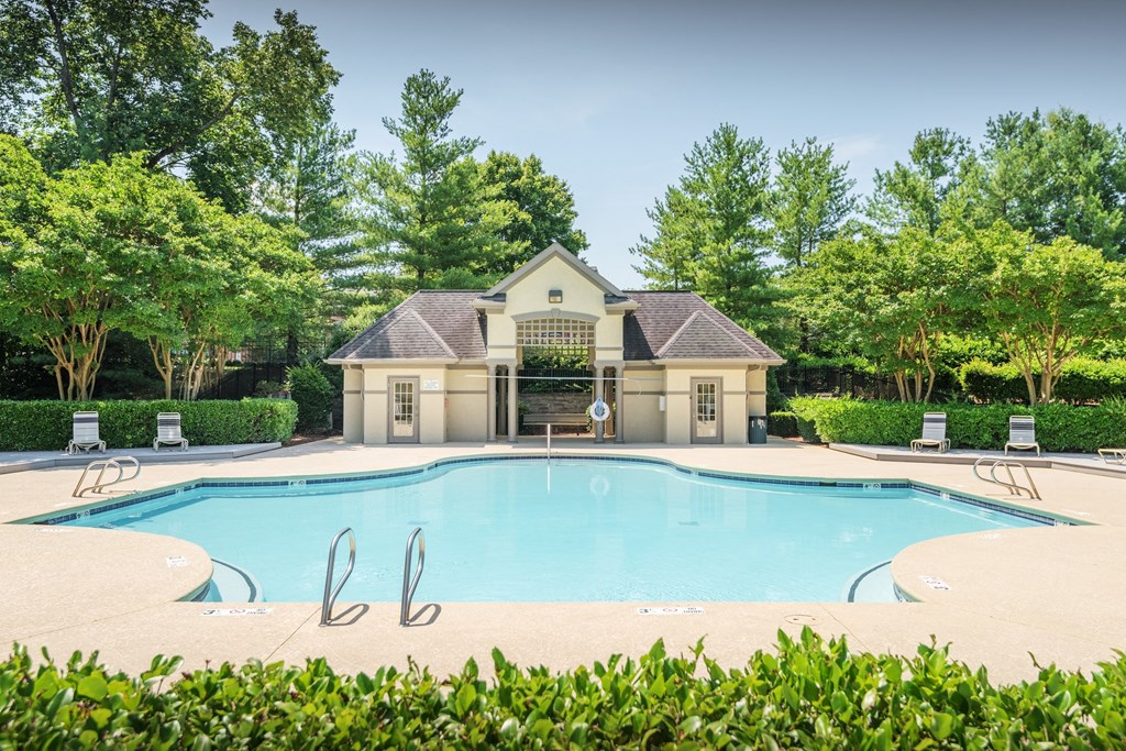 a swimming pool with a house in the background at The Madison at Adams Farm, Greensboro North Carolina