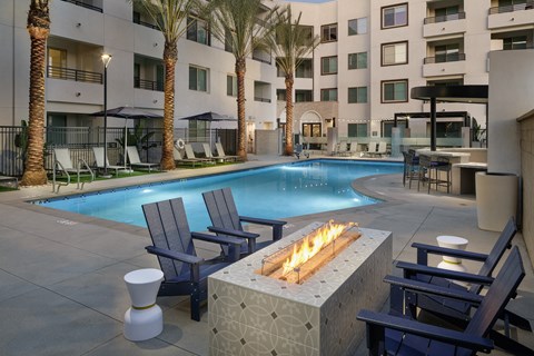A pool with a fire pit in the middle of it.