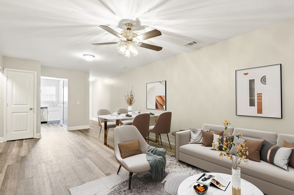 A living room with a couch, chairs, and a dining table.