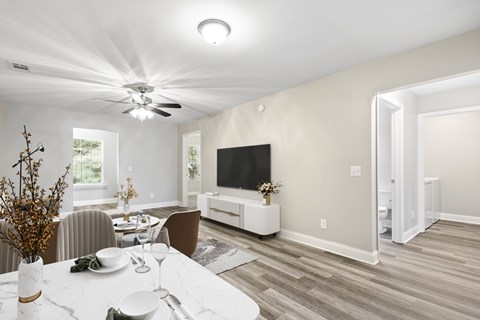 A modern dining room with a white table and chairs.