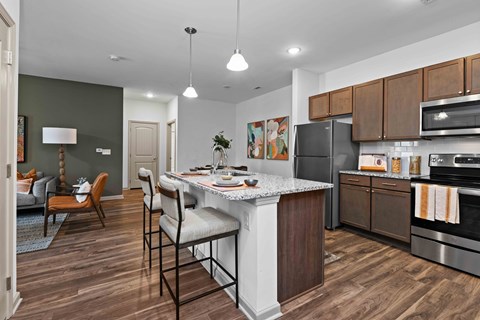 A kitchen with a white island and wooden cabinets.