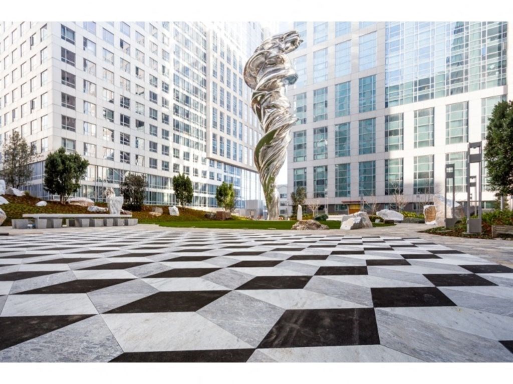 a large sculpture in front of a large building