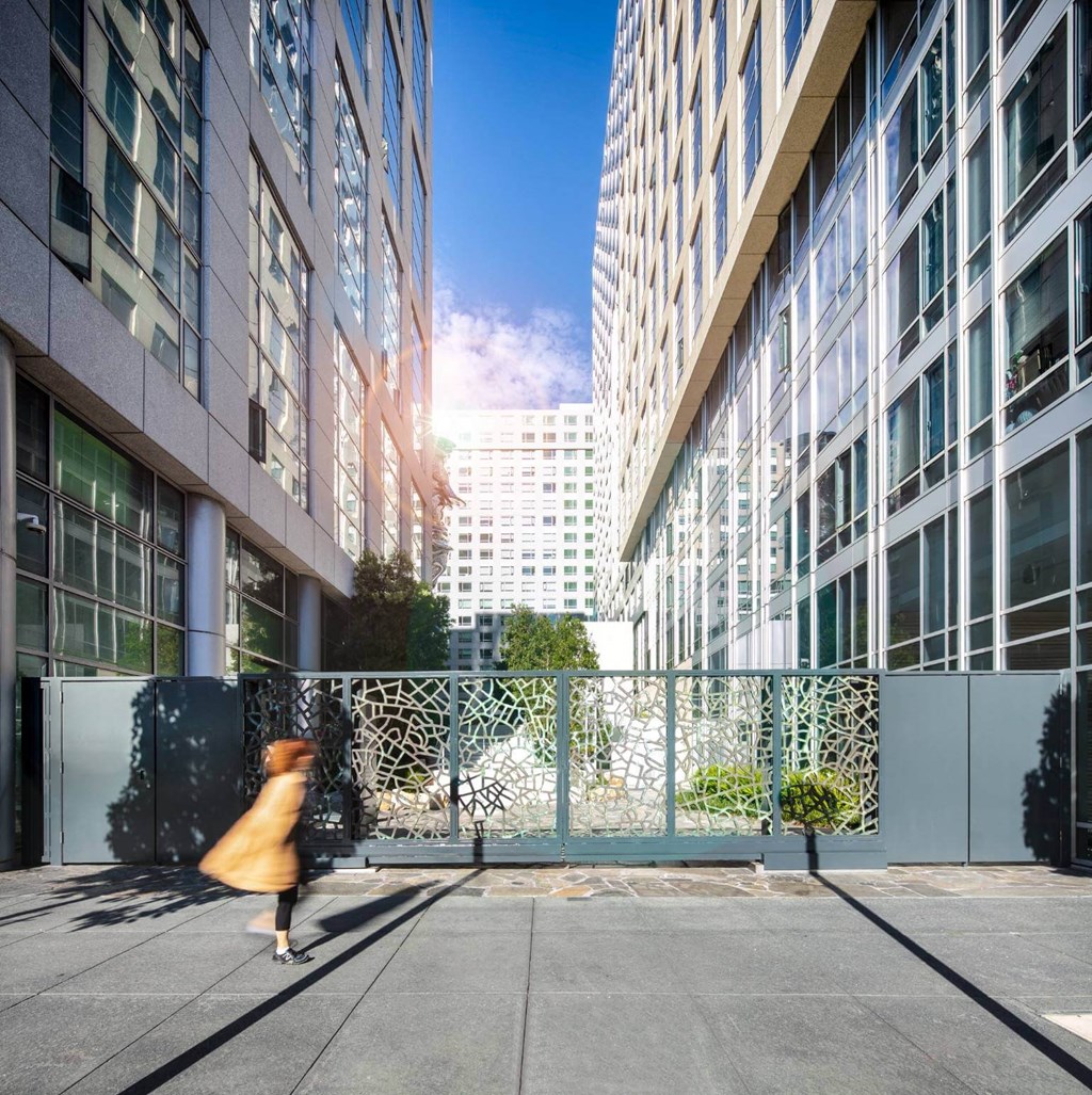 an image of a woman walking down a sidewalk in a large city