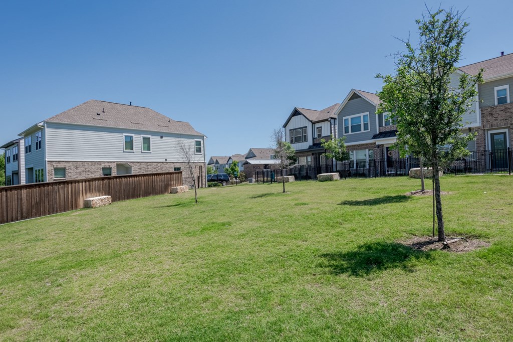 the backyard of a house with a yard and a tree