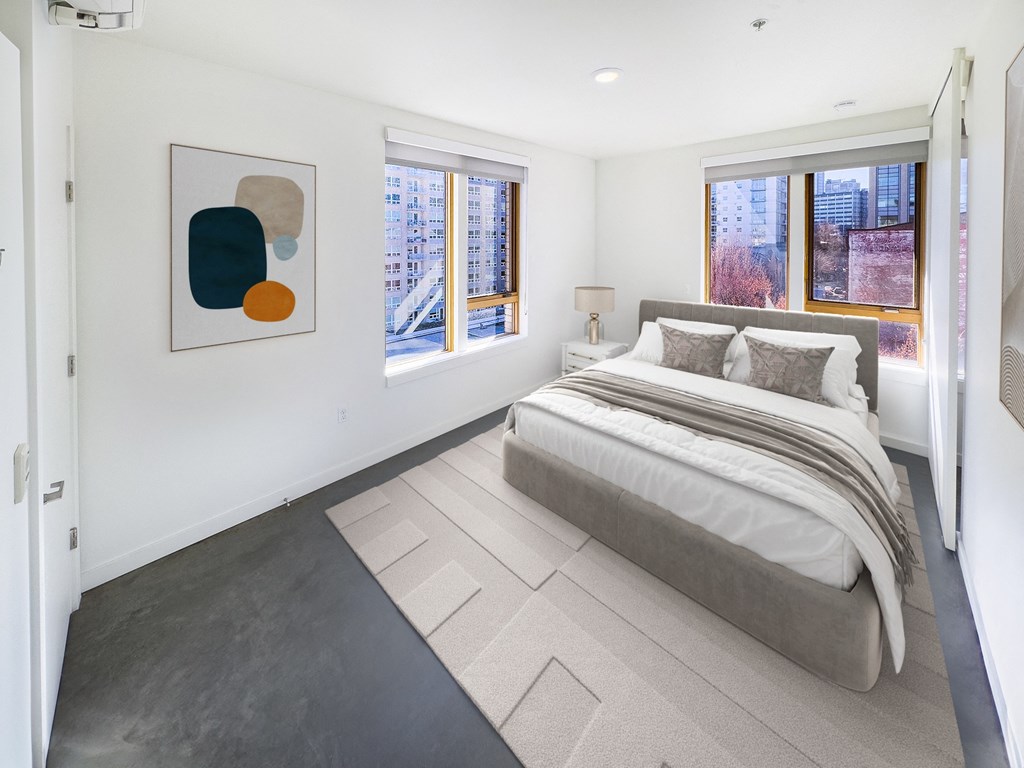 a bedroom with a bed and two windows