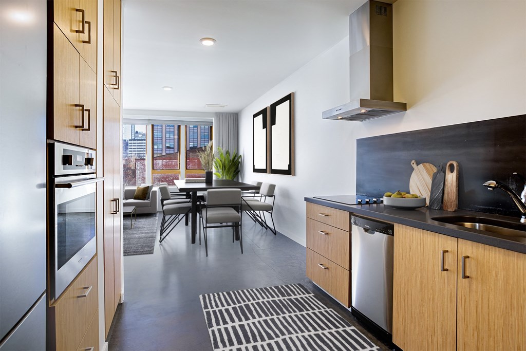 a kitchen and dining area with a table and chairs and a large window