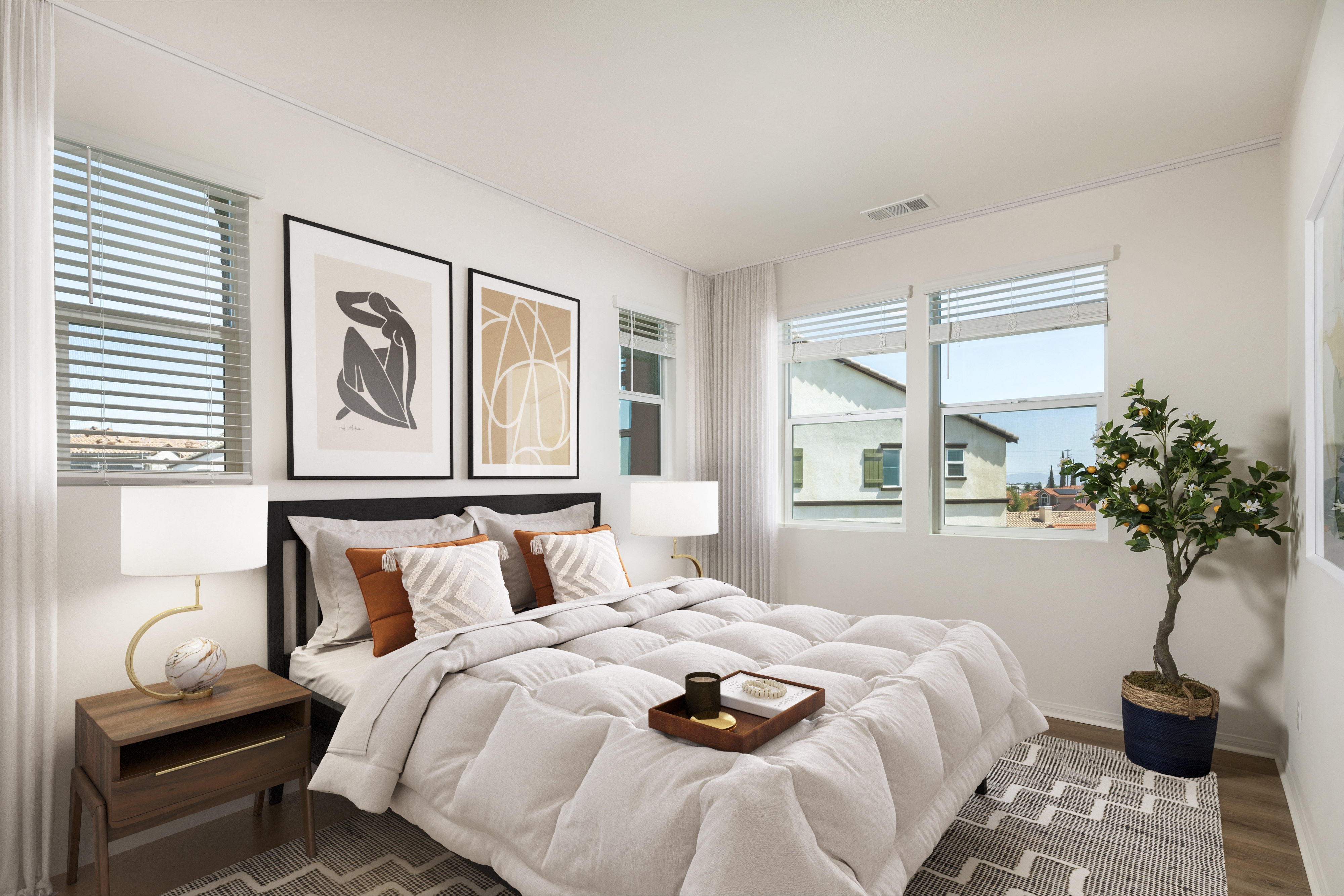 a bedroom with a large bed and pictures on the wall