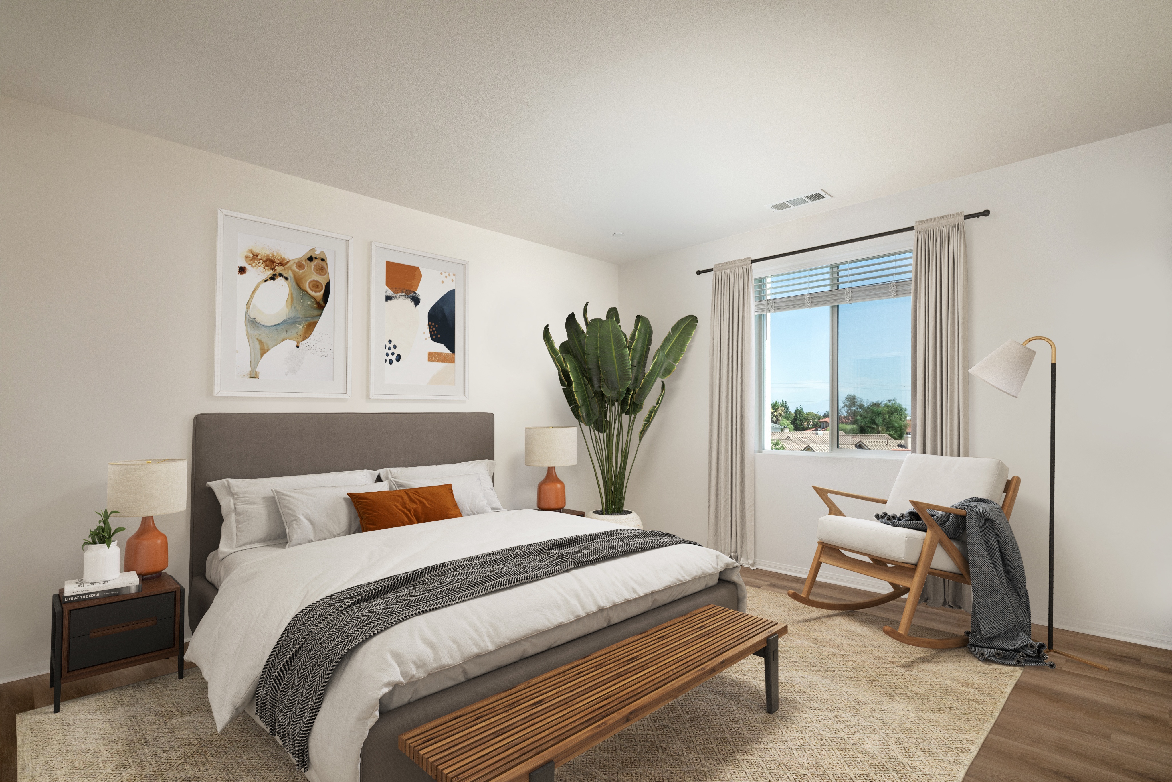 a bedroom with a bed and a chair and a window