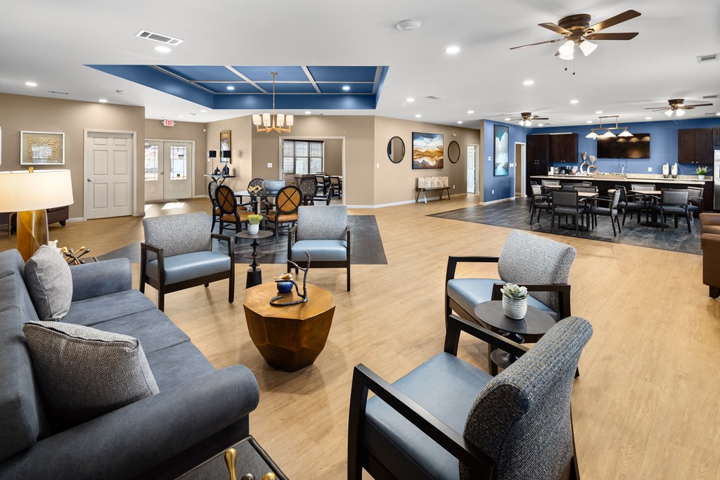 a large living room with couches and chairs and a dining room with a bar