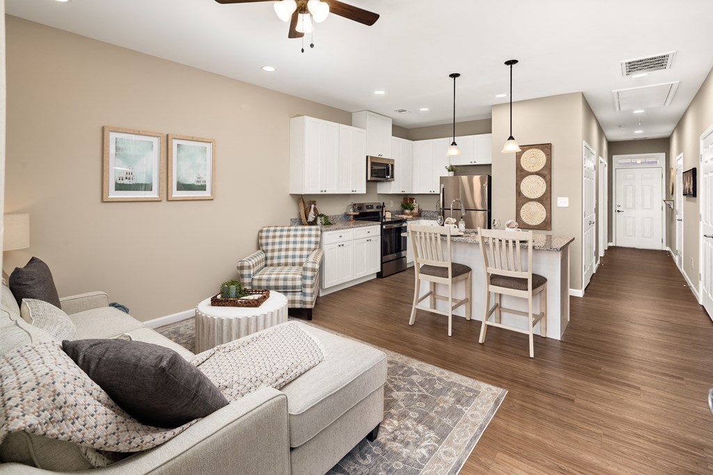 a living room and kitchen with a couch and a table