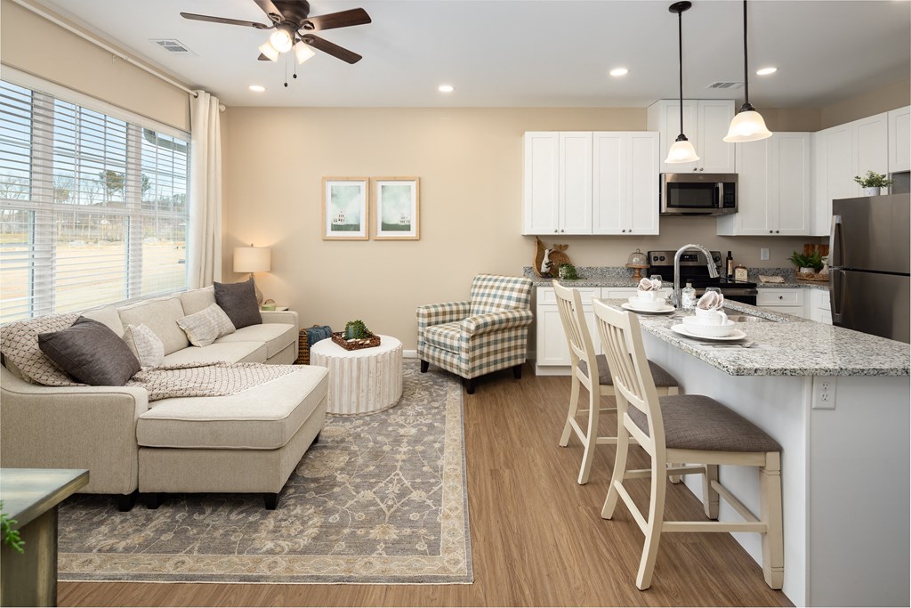 a living room and kitchen with a couch and a table