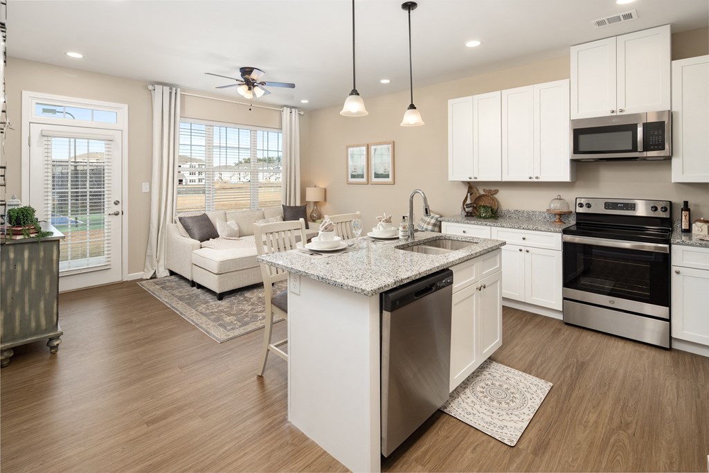 a kitchen with an island and a living room with a couch