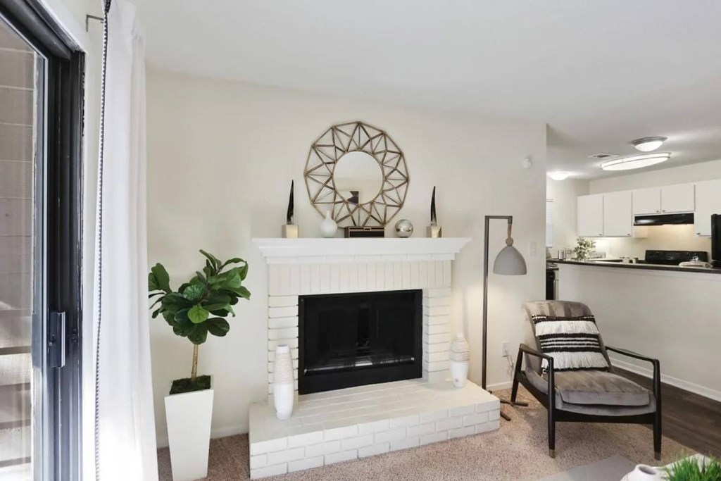 A living room with a fireplace and a chair.