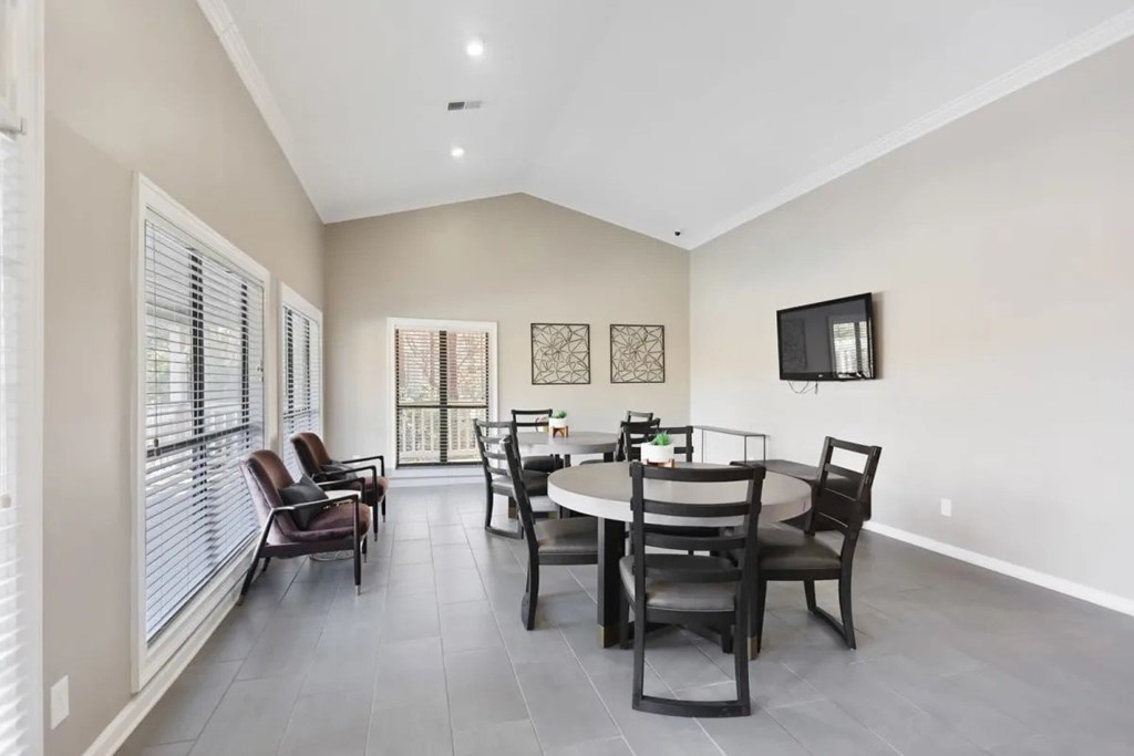 A dining room with a table set for four.