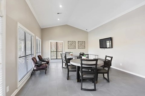 A dining room with a table set for four.