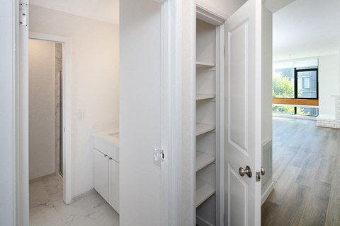 a bedroom with a medium sized bed and a mirror on the wall