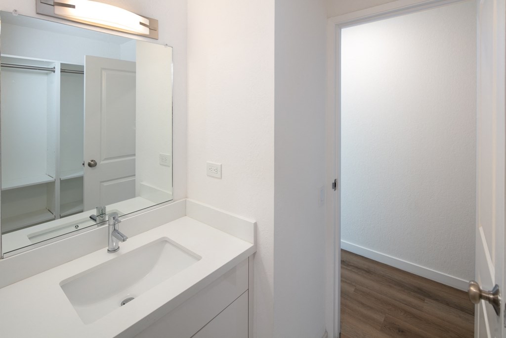 a bathroom with a sink and mirror in a 555 waverly unit