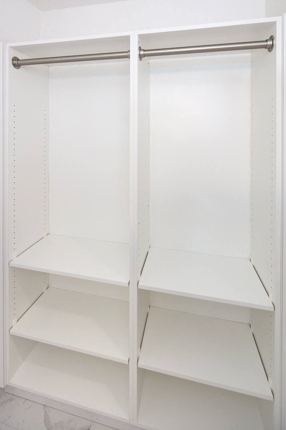 an empty pantry with the doors open