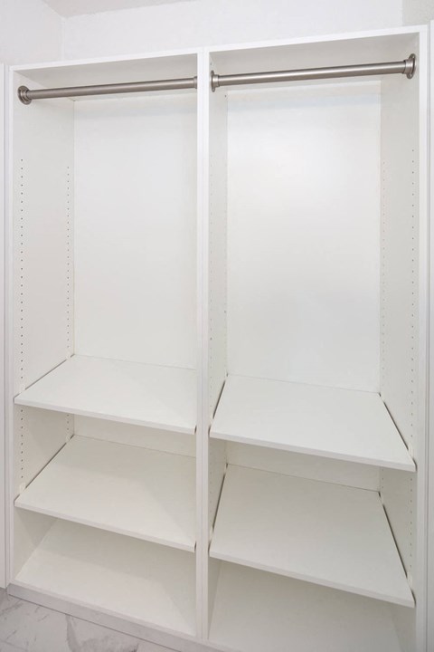 an empty pantry with the doors open