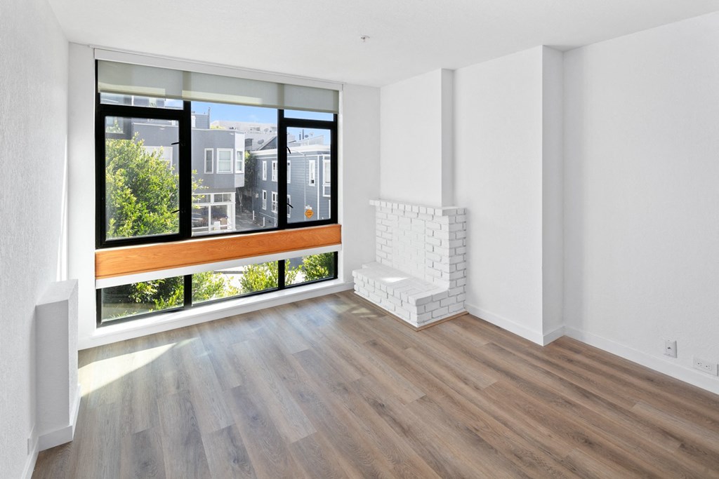 an empty living room with a large window
