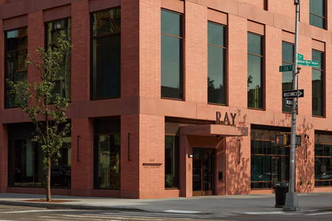 A red brick building with a sign that says "RAY" on the front.