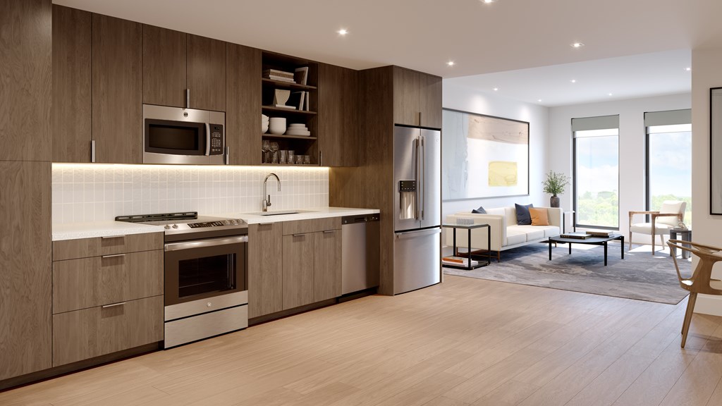 A modern kitchen with wooden cabinets and a white backsplash.