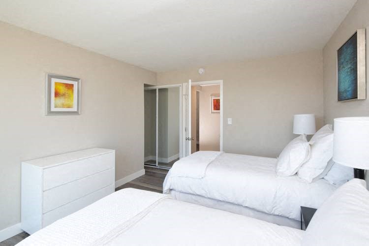 a bedroom with two beds and a dresser