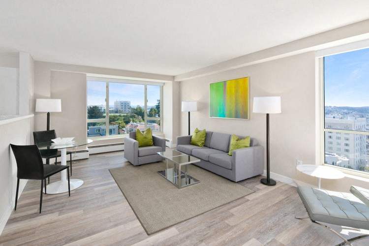 a living room with a gray couch and a glass coffee table