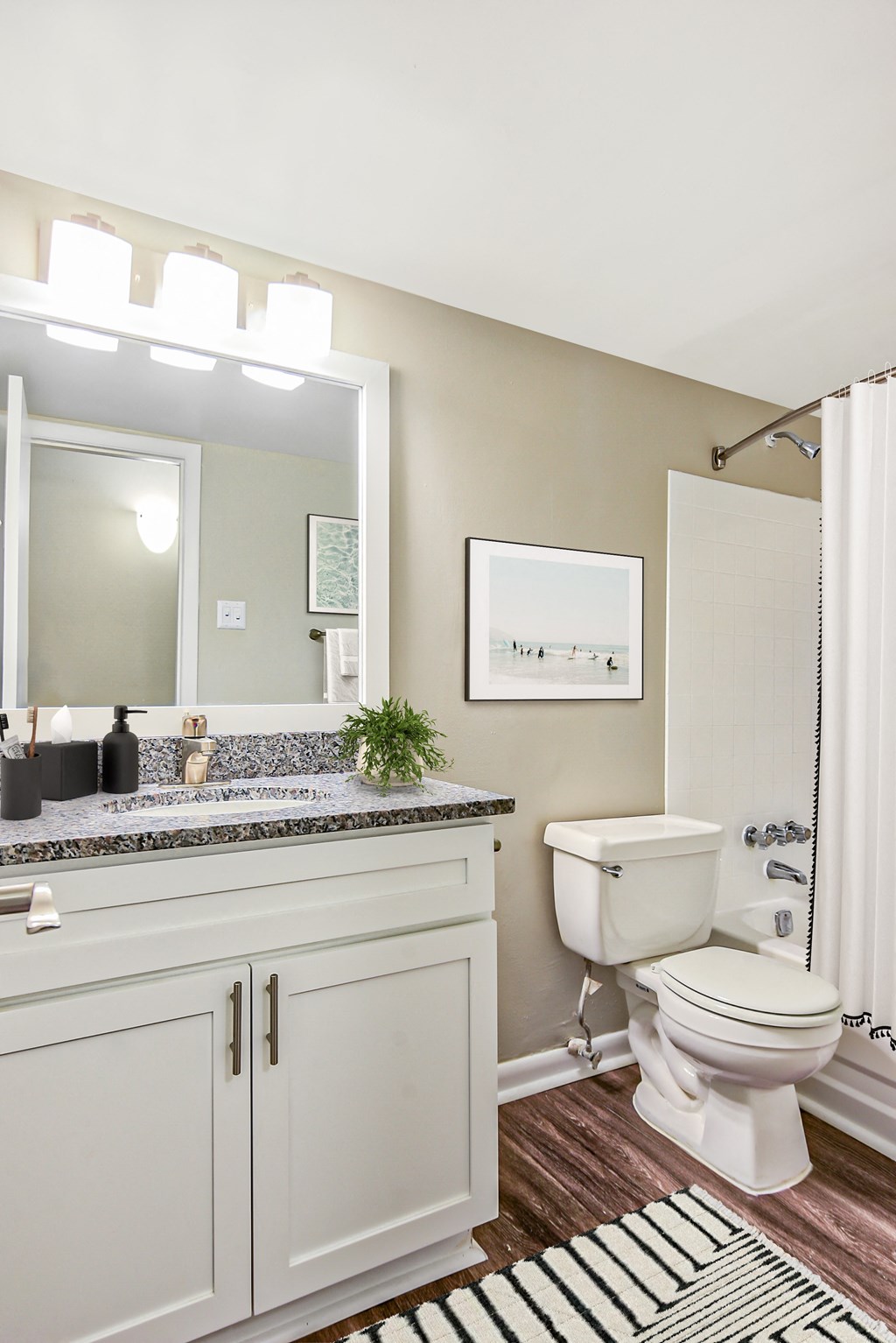a bathroom with white cabinets and a white shower curtain