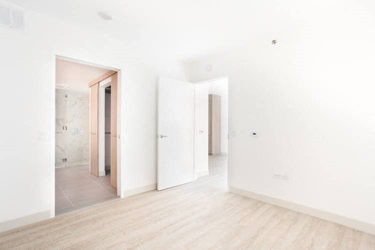 a large empty room with white walls and a wooden floor