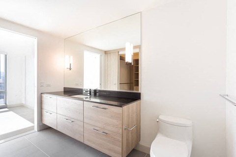 a bathroom with a toilet sink and mirror