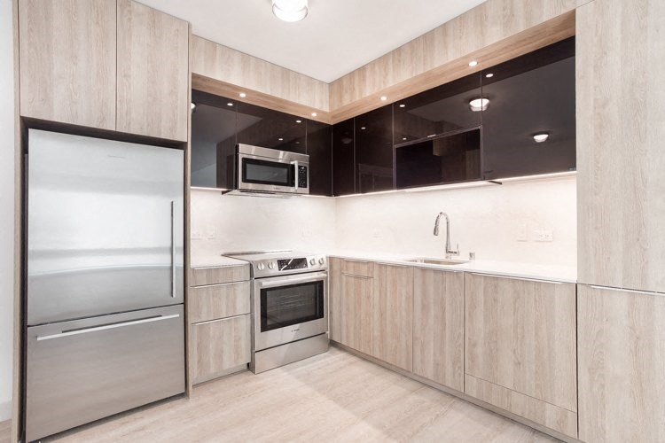 a kitchen with wooden cabinets and stainless steel appliances
