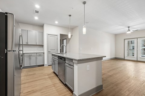 A modern kitchen with a refrigerator, cabinets, and a countertop.