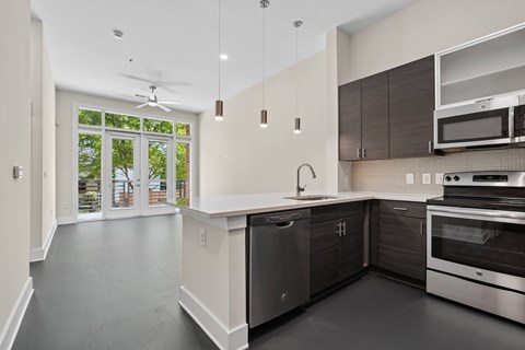 A modern kitchen with stainless steel appliances and a large island.