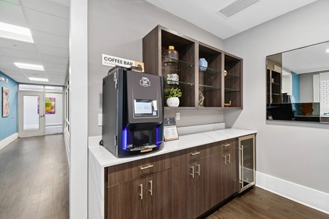 A coffee bar with a coffee machine and shelves with decorative items.