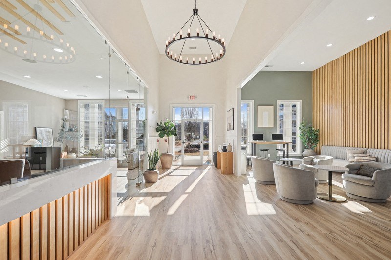 A modern office lobby with a reception desk and seating area.