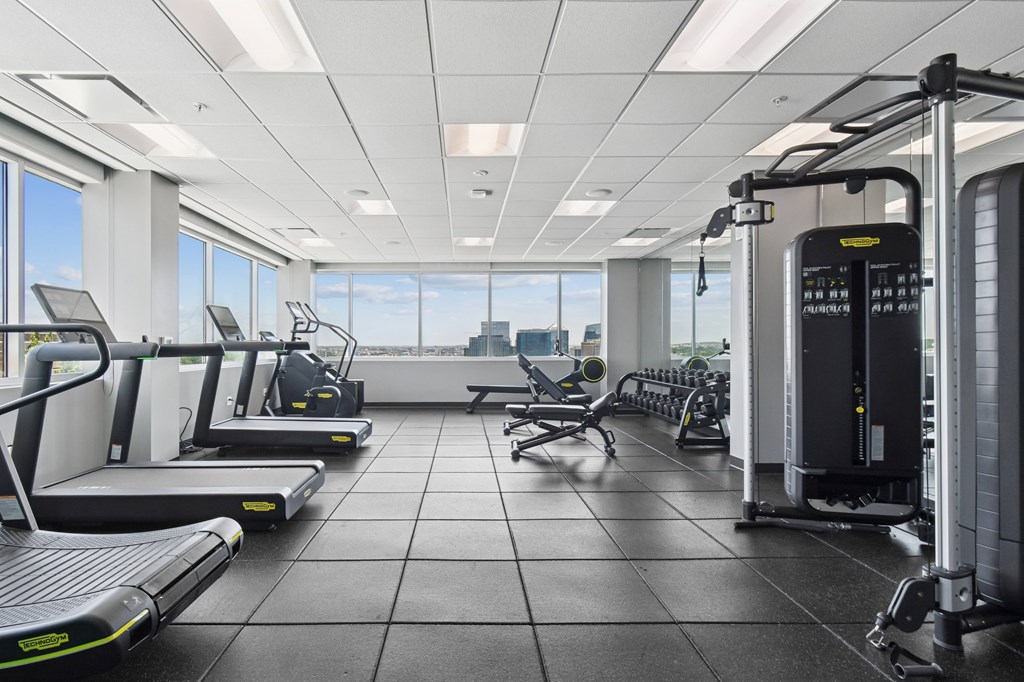 A gym with treadmills, exercise bikes, and other equipment.