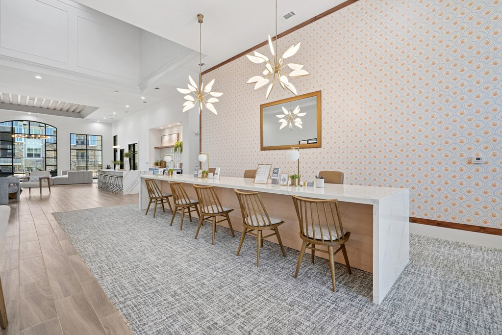 A long white table with chairs on it.