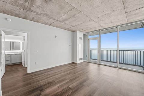 A room with a concrete ceiling and a balcony with a railing.