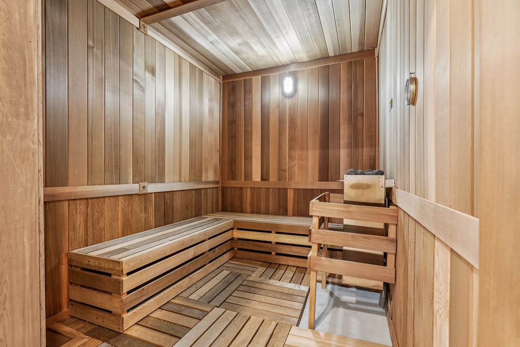 a sauna with wooden walls and a wooden bench