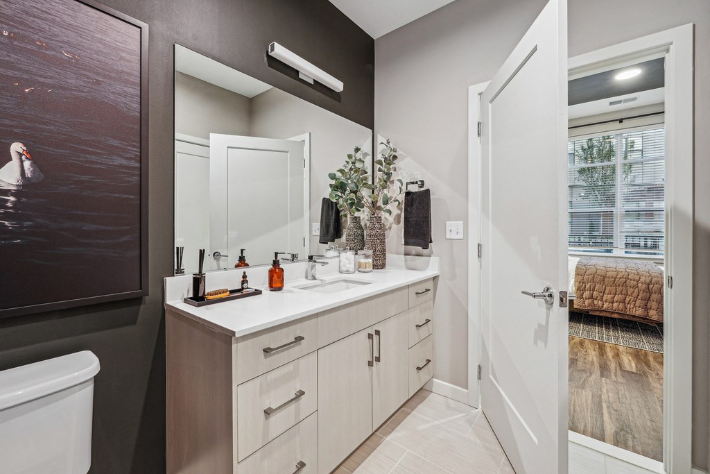 a bathroom with a large mirror and a white sink