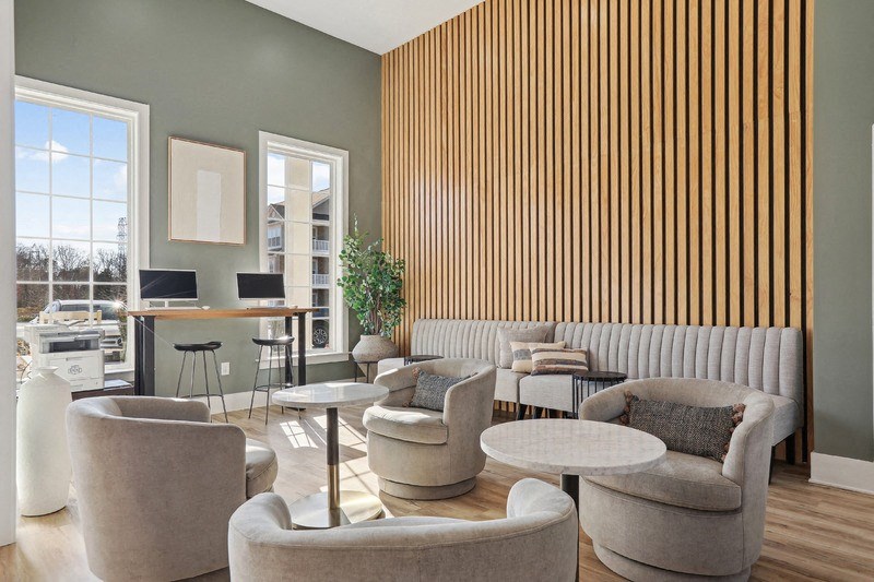 A living room with a wooden panel wall and a white sofa.