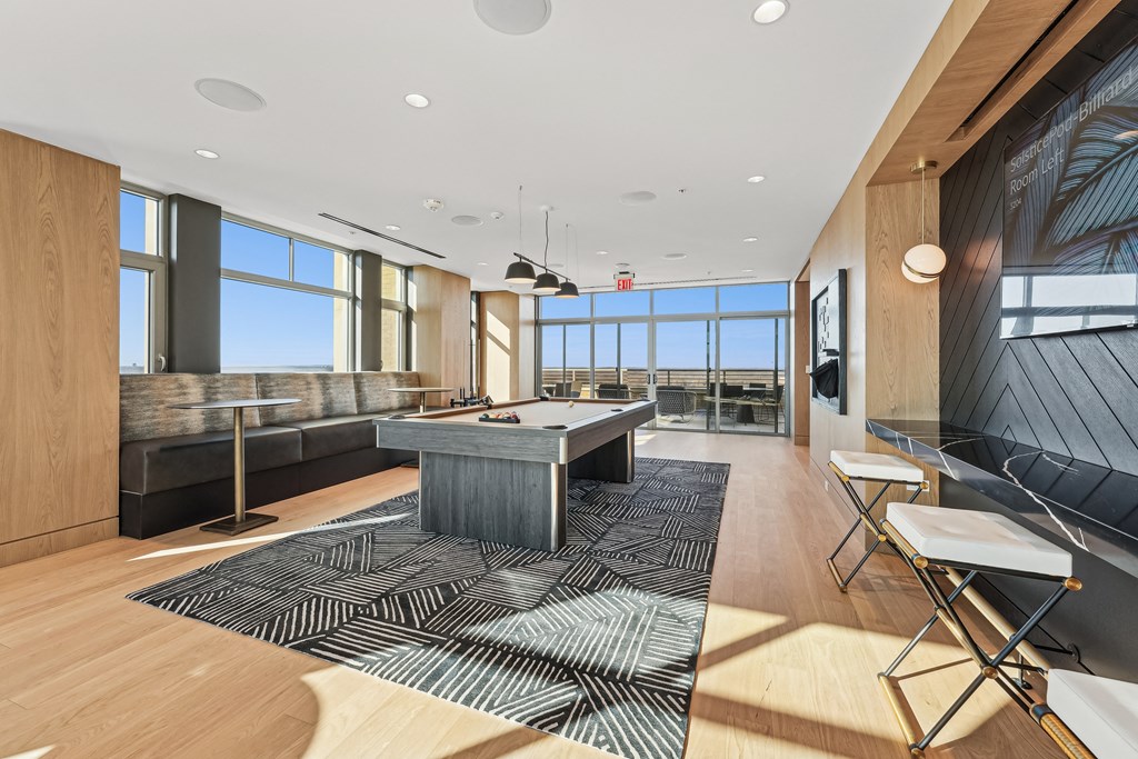 A modern living room with a large window and a wooden floor.