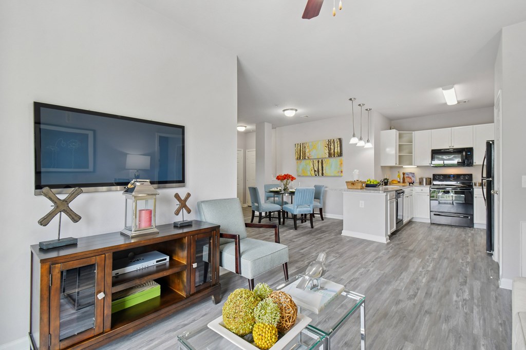 A modern living room with a flat screen TV on the wall.