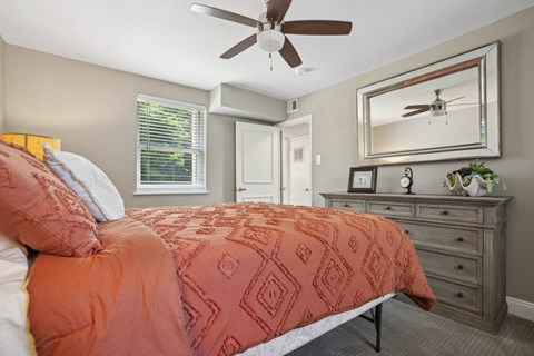 a bedroom with a bed and a ceiling fan