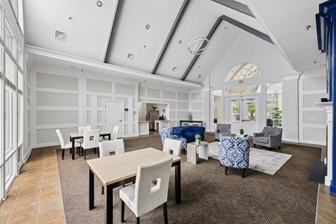 A spacious room with a dining table and chairs.
