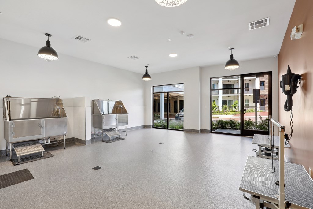 an empty room with two refrigerators in it and two glass doors