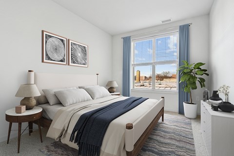 A bedroom with a large bed and two lamps.